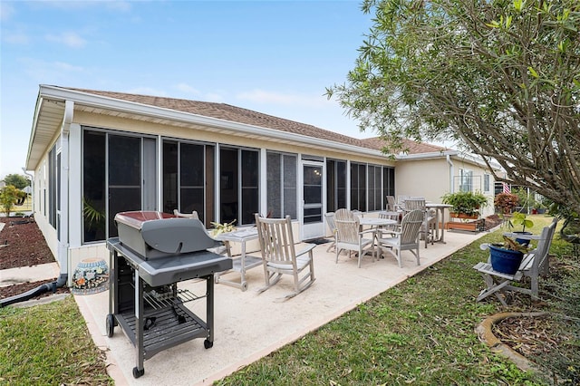 back of house featuring a sunroom and a patio area