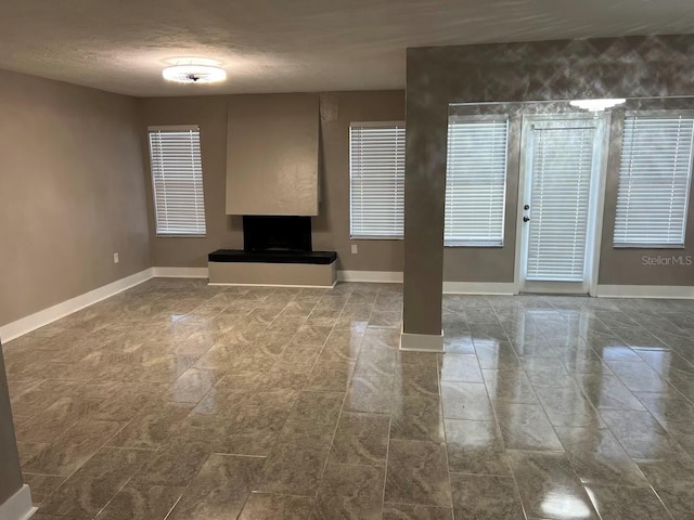 unfurnished living room with a textured ceiling