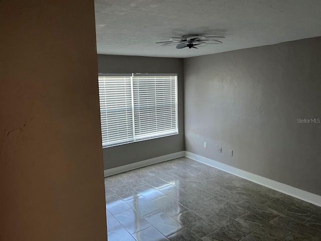 unfurnished room featuring a textured ceiling and ceiling fan