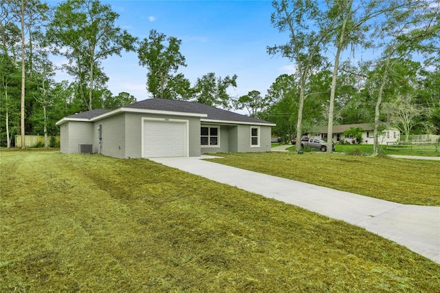 single story home with cooling unit, a front yard, and a garage