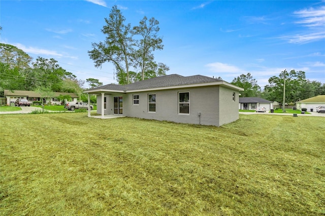 rear view of house with a yard