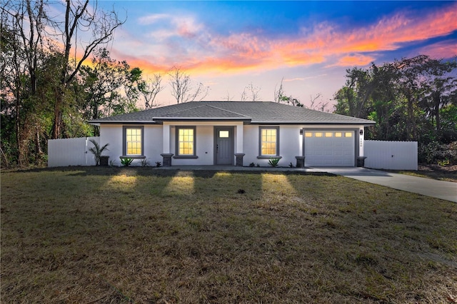 view of front of house featuring a lawn and a garage