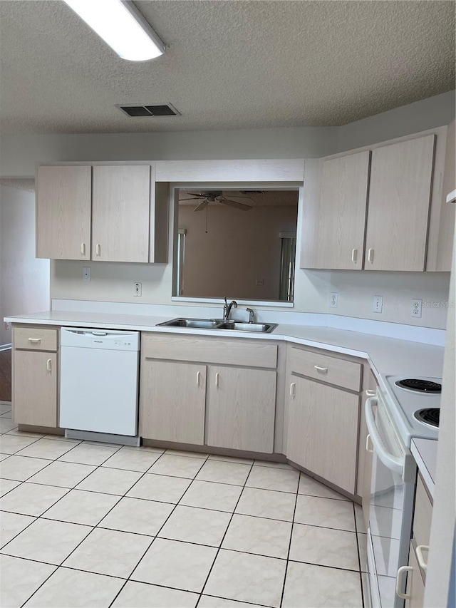 kitchen featuring sink, a textured ceiling, white appliances, ceiling fan, and light tile patterned floors