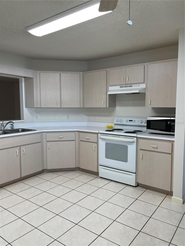 kitchen featuring white electric stove, a textured ceiling, light brown cabinetry, sink, and light tile patterned flooring