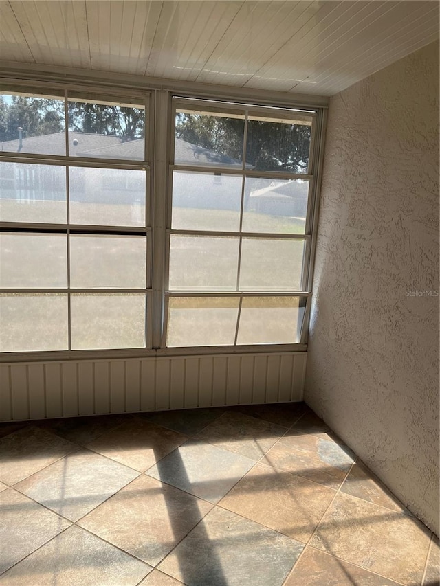 unfurnished sunroom with wood ceiling