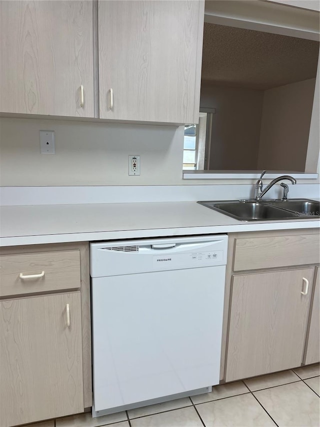 kitchen featuring white dishwasher, light tile patterned flooring, sink, and light brown cabinets