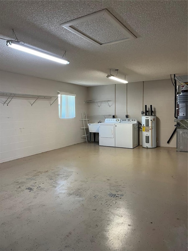 garage featuring independent washer and dryer and electric water heater