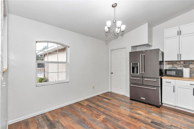 kitchen with vaulted ceiling, backsplash, white cabinetry, dark wood-type flooring, and high end refrigerator