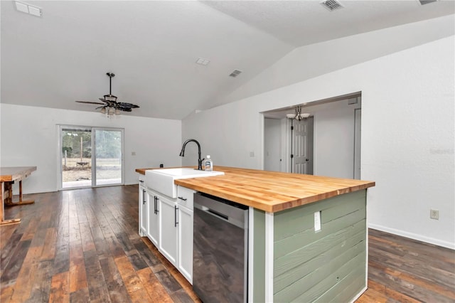 kitchen with dishwasher, sink, white cabinets, a center island with sink, and wood counters