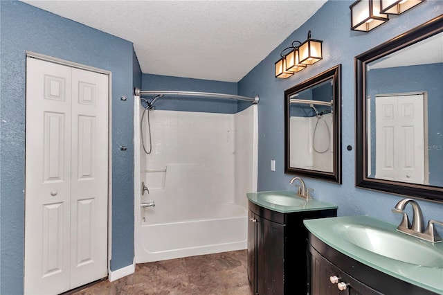 bathroom featuring a textured ceiling, shower / tub combination, and vanity