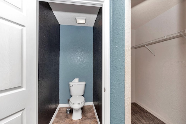 bathroom featuring a textured ceiling and toilet