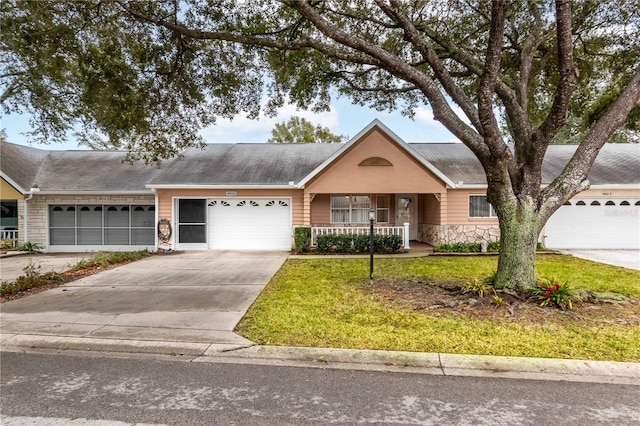 single story home with a garage, a front lawn, and a porch