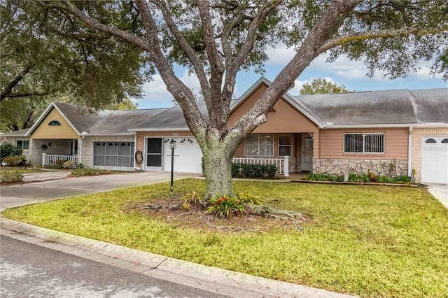 ranch-style house with a porch, a garage, and a front yard