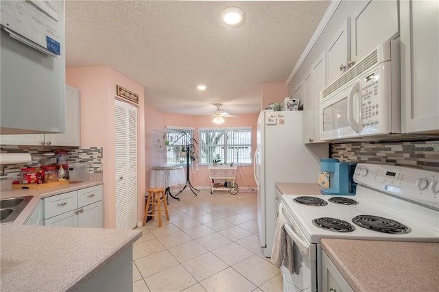 kitchen with ceiling fan, white cabinets, light tile patterned floors, white appliances, and decorative backsplash