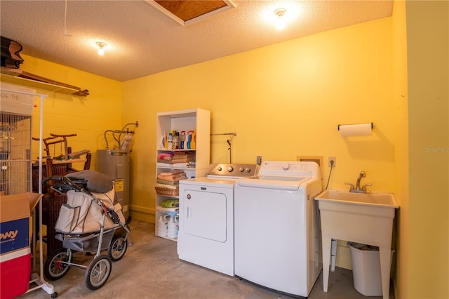 laundry room featuring a textured ceiling, electric water heater, and washing machine and dryer