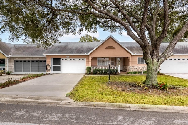 ranch-style house featuring a garage, covered porch, stone siding, driveway, and a front yard