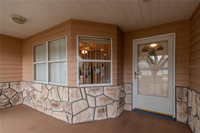entrance to property featuring stone siding