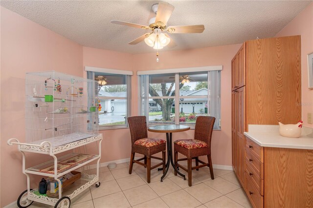 9051 SW 96th Ln Unit B, Ocala, FL 34481 - dining room featuring a textured ceiling, healthy amount of natural light, baseboards, and light tile patterned floors