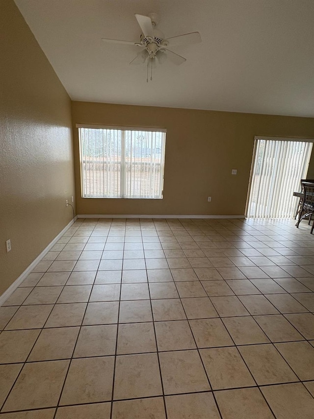 tiled empty room featuring ceiling fan