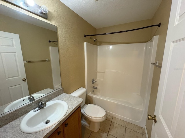 full bathroom featuring toilet, vanity, tile patterned flooring, a textured ceiling, and bathing tub / shower combination