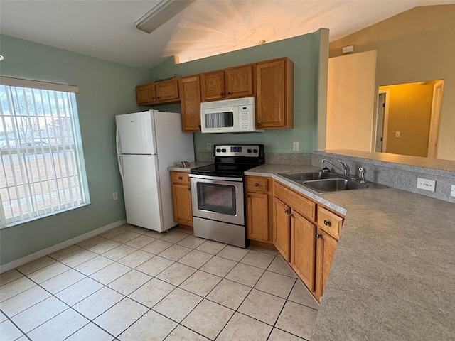 kitchen with light tile patterned floors, vaulted ceiling, sink, and white appliances