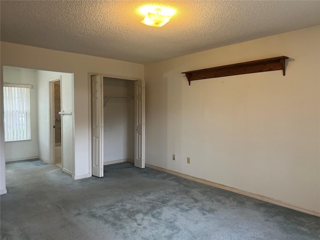 unfurnished bedroom with a closet, a textured ceiling, and carpet flooring