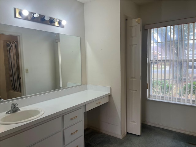 bathroom with vanity, plenty of natural light, and shower / tub combo with curtain