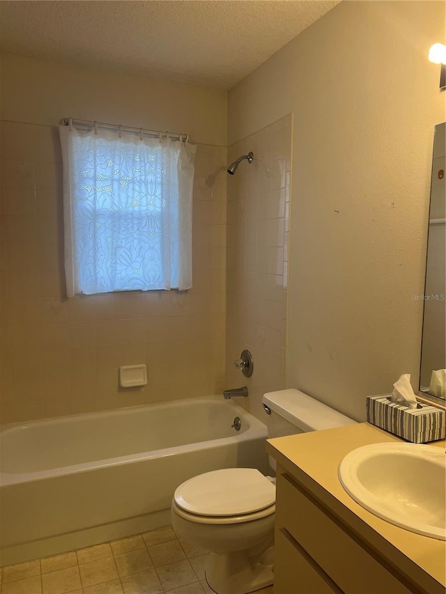 full bathroom featuring vanity, a textured ceiling, tile patterned floors, toilet, and tiled shower / bath