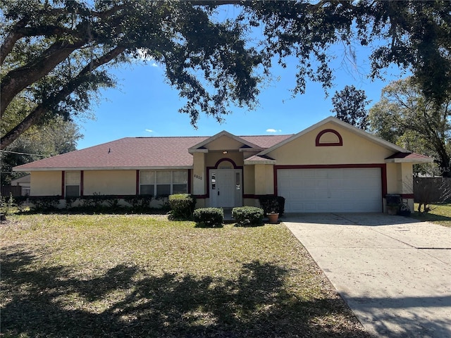 single story home with a front lawn, driveway, an attached garage, and stucco siding