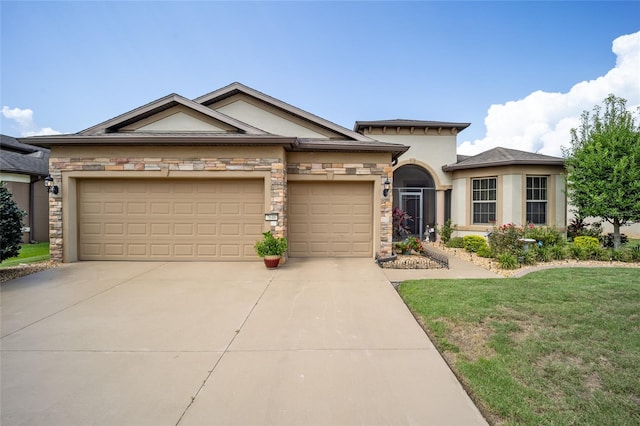 view of front of home with a garage and a front lawn