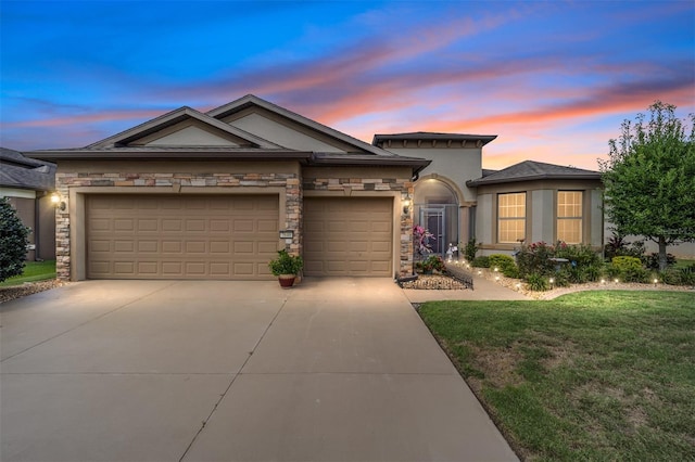 view of front of house featuring a lawn and a garage