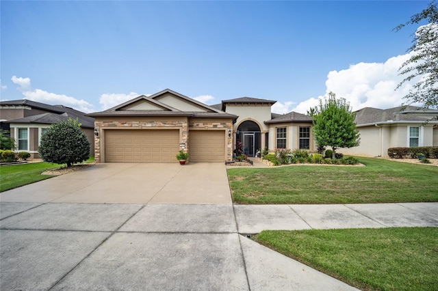 view of front of home featuring a front yard and a garage