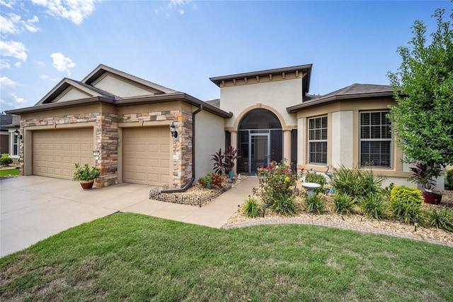 view of front of property with a garage and a front lawn