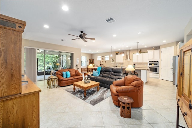 living room with ceiling fan and light tile patterned floors