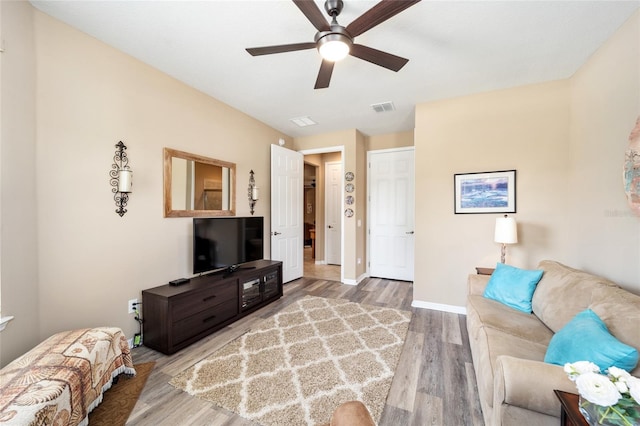 living room featuring ceiling fan and hardwood / wood-style flooring