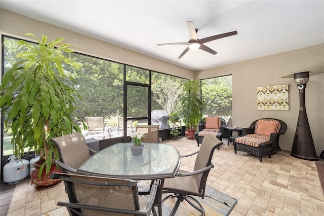 sunroom featuring ceiling fan