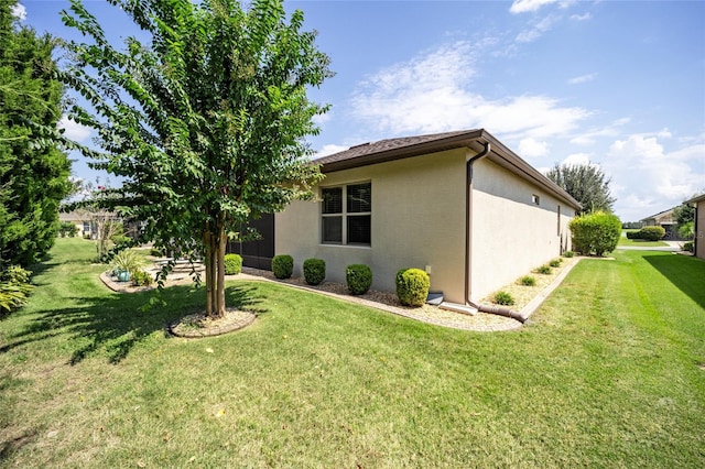 view of side of home featuring a lawn