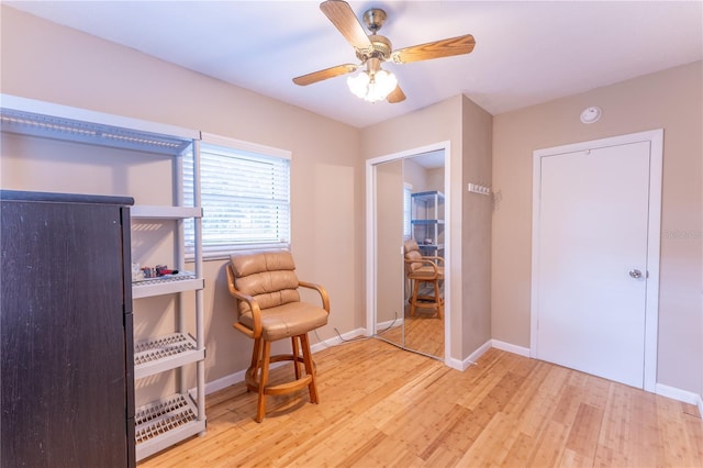 living area featuring ceiling fan and light hardwood / wood-style flooring