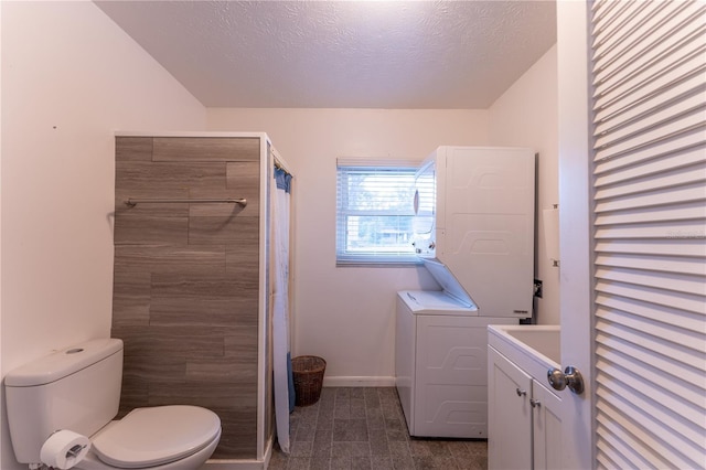 bathroom with stacked washer and clothes dryer, walk in shower, a textured ceiling, and toilet