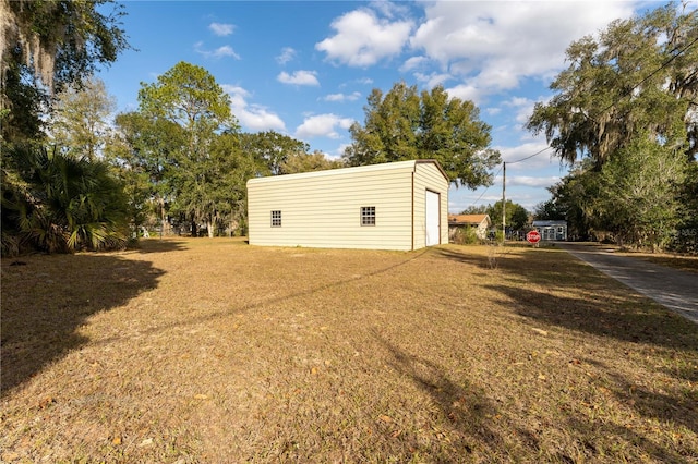 exterior space featuring a garage and an outbuilding