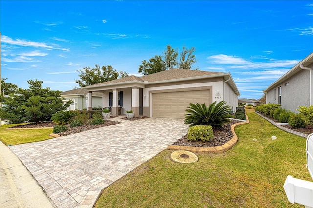 view of front of house with a front yard and a garage