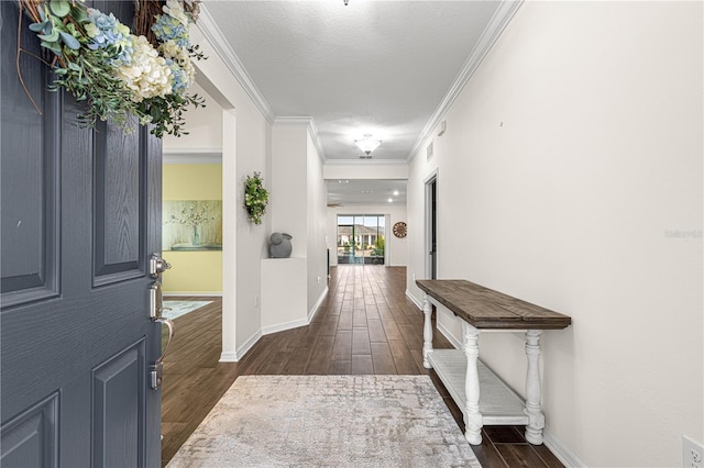 entrance foyer with a textured ceiling, dark hardwood / wood-style floors, and crown molding