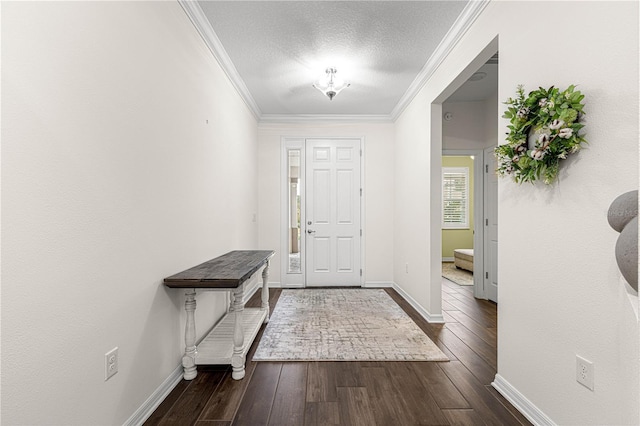 entrance foyer with a textured ceiling, dark hardwood / wood-style flooring, and ornamental molding