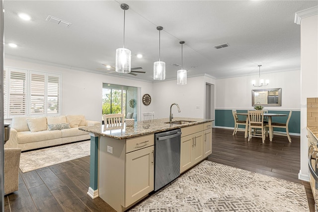 kitchen featuring decorative light fixtures, sink, cream cabinets, light stone counters, and stainless steel dishwasher