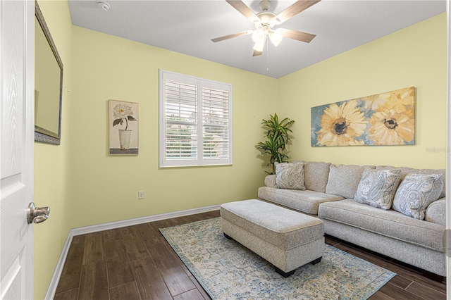 living room featuring ceiling fan and dark hardwood / wood-style floors