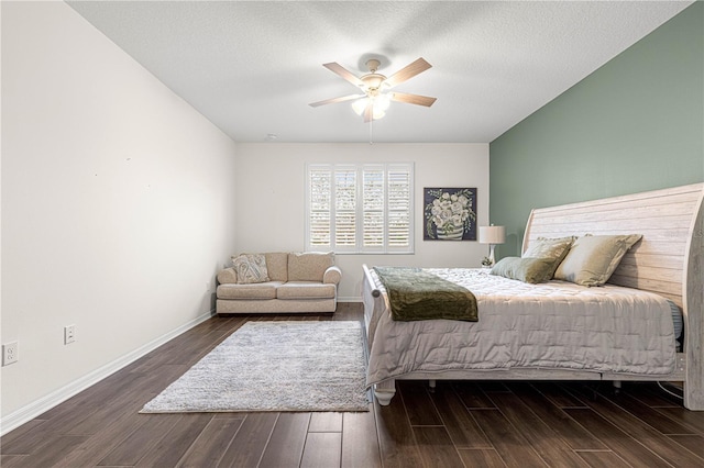 bedroom featuring ceiling fan, dark wood-type flooring, and a textured ceiling