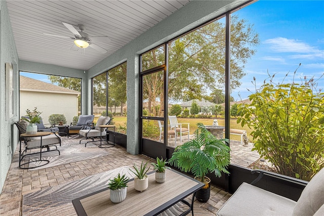 sunroom featuring ceiling fan