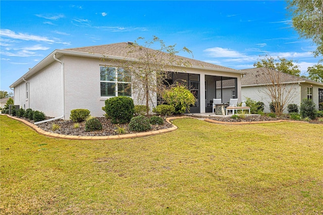 back of property featuring a yard and a sunroom