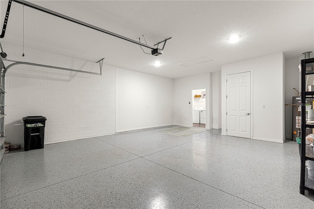 garage with water heater and a garage door opener