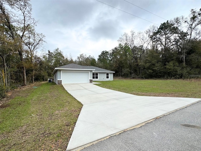 view of front of property with an attached garage, concrete driveway, and a front yard